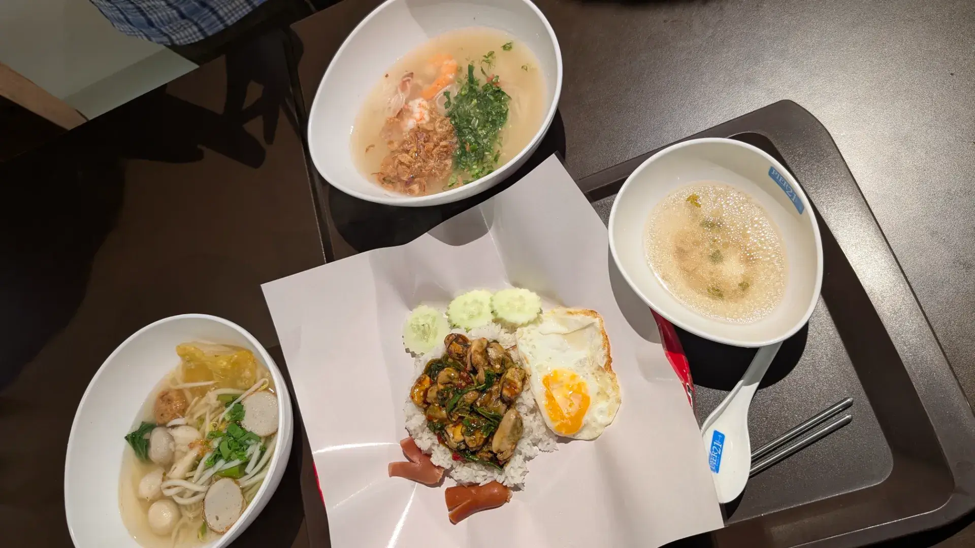 タイのショッピングモール「ターミナル21」のフードコート（PIER 21）で楽しむタイ料理。ガパオライスや魚のすり身入りヌードルなど、安くて美味しい本場の味を堪能できる旅の食事風景です。